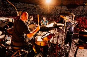 Coldplay performing at a stadium.