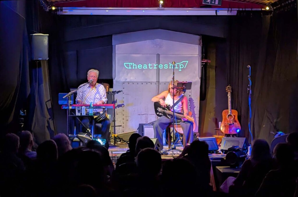 Glenn & Leon Tilbrook perform on stage playing piano and acoustic guitar at Theatreship credit Music Venue Trust
